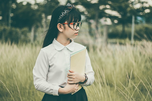 Young student posing with a textbook