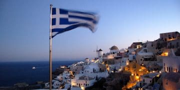 Santorini at night, with a Greek flag in the foreground