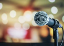 Microphone,On,Abstract,Blurred,Of,Speech,In,Seminar,Room,Or