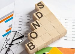 Bonds,Words,With,Wooden,Blocks,On,Chart,Background.,Business,Concept. Bonds,Words,With,Wooden,Blocks,On,Chart,Background.,Business,Concept.